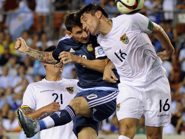 MATADOR. Podría ser una foto de Kempes o Batistuta, por la fiereza del gesto en la lucha aérea con el defensor. Pero es Messi, ganándole en el salto al capitán boliviano Ronald Raldes y convirtiendo su primer gol, después de un excelente centro de Casco. 